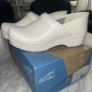 Dansko white nursing shoes.